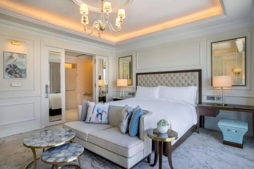 a hotel room with a bed and a couch at The Ritz-Carlton, Amman in Amman