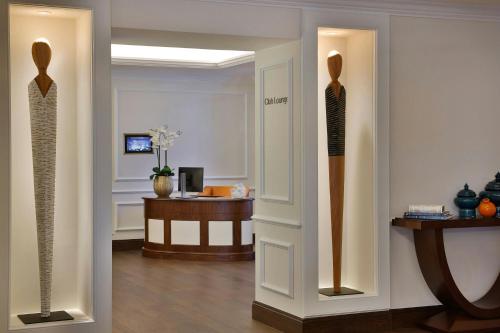 a room with two mannequins on the wall and a table at The Ritz-Carlton, Amman in Amman