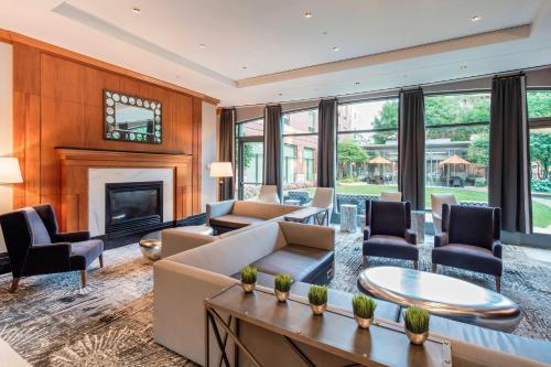 a living room with a couch and a fireplace at Courtyard by Marriott Boston Brookline in Brookline