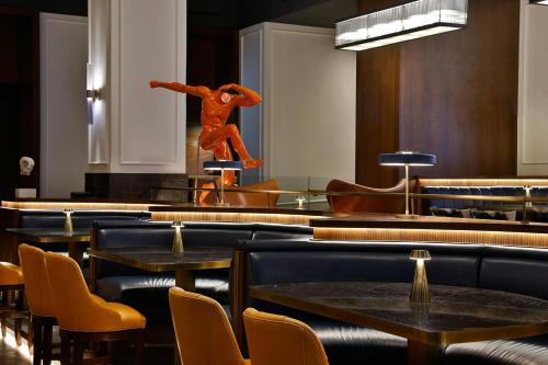 a restaurant with tables and a statue of a man on the wall at The Ritz-Carlton, Amman in Amman