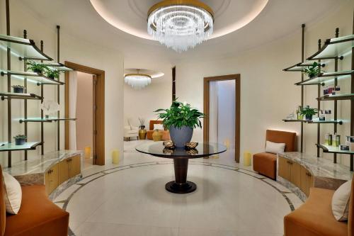 a room with a table with a potted plant on it at The Ritz-Carlton, Amman in Amman