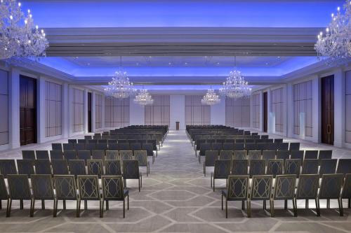 an empty banquet hall with chairs and chandeliers at The Ritz-Carlton, Amman in Amman
