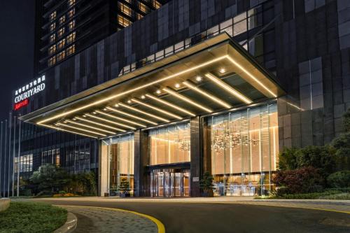 a building with a lit up facade at night at Courtyard by Marriott Foshan Gaoming in Foshan