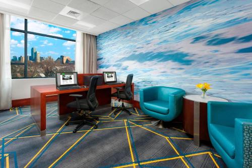 an office with a large painting on the wall at Courtyard by Marriott Boston Cambridge in Cambridge