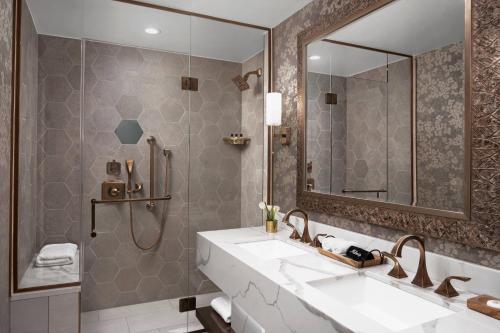 a bathroom with a sink and a mirror at The Lytle Park Hotel, Autograph Collection in Cincinnati