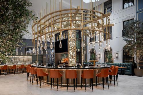 a restaurant with a large chandelier in a building at The Lytle Park Hotel, Autograph Collection in Cincinnati