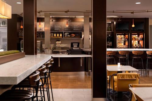 a bar in a restaurant with bar stools at Courtyard Los Angeles Century City/Beverly Hills in Los Angeles