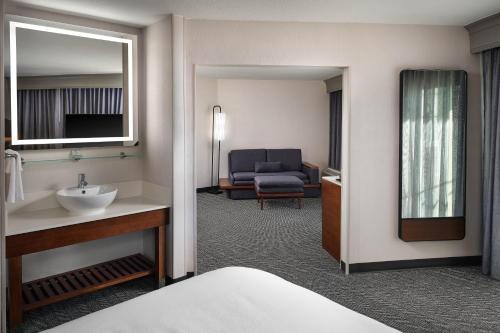 a hotel room with a sink and a living room at Courtyard Los Angeles Century City/Beverly Hills in Los Angeles