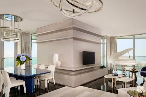 a living room with a blue table and a fireplace at Paragraph Resort & Spa Shekvetili, Autograph Collection in Shekvetili
