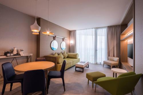 a living room with a couch and a table at Paragraph Resort & Spa Shekvetili, Autograph Collection in Shekvetili