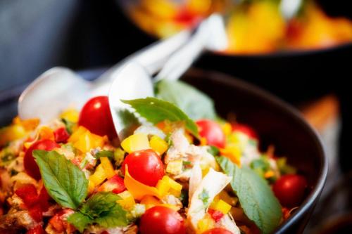 a bowl of salad with tomatoes and other vegetables at Paragraph Resort & Spa Shekvetili, Autograph Collection in Shekvetili