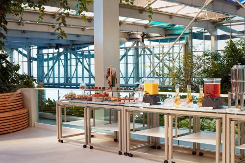 two tables with food on them in a building at Paragraph Resort & Spa Shekvetili, Autograph Collection in Shekvetili