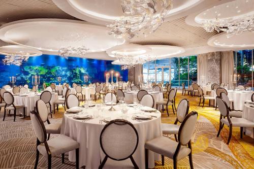 a banquet hall with tables and chairs and chandeliers at Paragraph Resort & Spa Shekvetili, Autograph Collection in Shekvetili