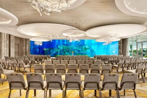 a conference room with chairs and a large screen at Paragraph Resort & Spa Shekvetili, Autograph Collection in Shekvetili