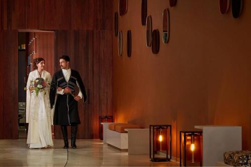 a bride and groom standing next to each other on a stage at Paragraph Resort & Spa Shekvetili, Autograph Collection in Shekvetili