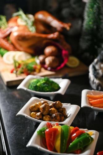 a bunch of plates of food on a table at Kempinski Residences Guangzhou - Free shuttle between hotel and Exhibition Center during Canton Fair & Exhibitor registration Counter in Guangzhou