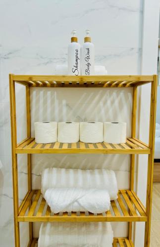a shelf with towels and toilet paper on it at LOFT 3 - Space & Conform Close To Center in Valencia