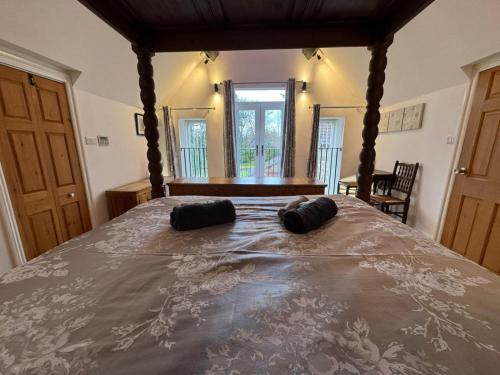 a bedroom with a bed with two pillows on it at Castle House Holiday Home in Chapel en le Frith