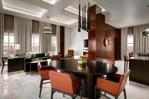 a living room with a black table and chairs at The Sinclair, Autograph Collection in Fort Worth