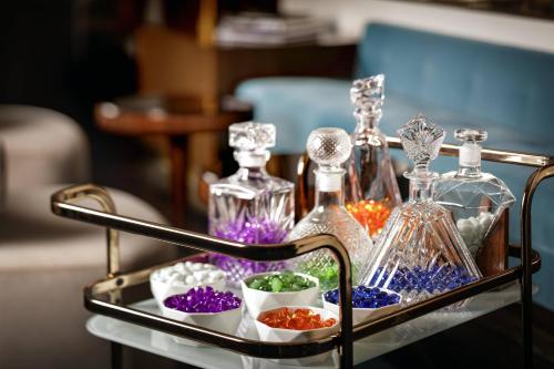 a tray with glass bottles on a table at The Sinclair, Autograph Collection in Fort Worth
