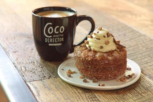 a cupcake on a plate next to a cup of coffee at Charlotte Marriott City Center in Charlotte