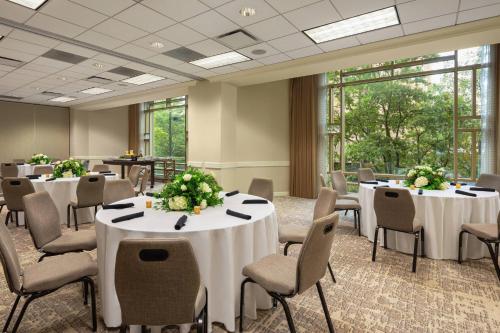 a conference room with tables and chairs with flowers on them at Charlotte Marriott City Center in Charlotte
