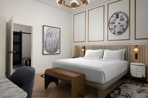 a bedroom with a large white bed and a table at The Union Station Nashville Yards, Autograph Collection in Nashville