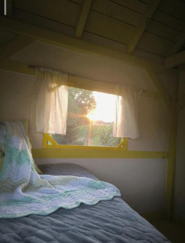 a bed in a room with a window at Apartma in wellness Čista fantazija in Velika Polana