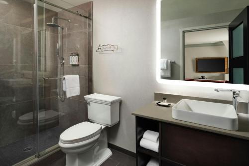 a bathroom with a toilet and a sink and a shower at The Union Station Nashville Yards, Autograph Collection in Nashville