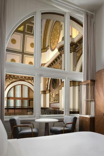 a room with a large window with chairs and a table at The Union Station Nashville Yards, Autograph Collection in Nashville