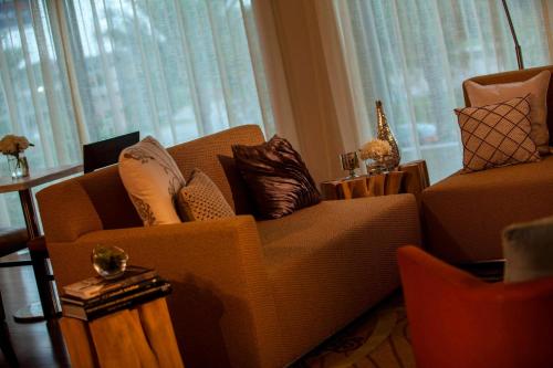 a living room with a couch and a chair at Renaissance Baton Rouge Hotel in Baton Rouge
