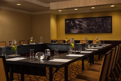a conference room with a long table with glasses on it at Renaissance Baton Rouge Hotel in Baton Rouge