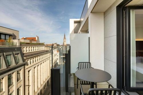 a balcony with a table and a view of a city at Moxy Brussels City Center in Brussels