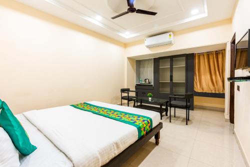 a bedroom with a bed and a desk at Treebo Edge Raipur Railway Station in Raipur