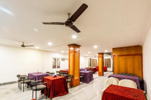 a dining room with purple tables and chairs at Treebo Edge Raipur Railway Station in Raipur