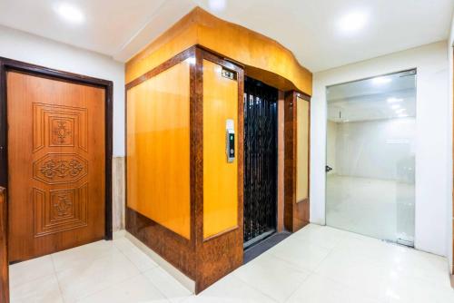 a elevator with a wooden door in a room at Treebo Edge Raipur Railway Station in Raipur