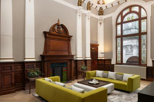 a living room with two couches and a fireplace at AC Hotel by Marriott Glasgow in Glasgow
