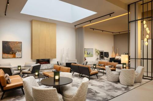 a lobby with couches tables and chairs at AC Hotel by Marriott Glasgow in Glasgow