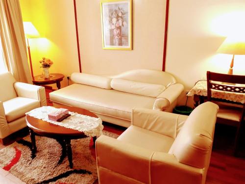 a living room with a couch and chairs and a table at Fantastic appartment at times square Kuala Lumpur in Kuala Lumpur