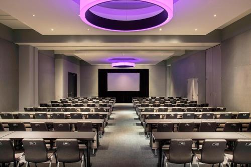 an empty lecture hall with chairs and a projection screen at Aloft Boston Seaport District in Boston