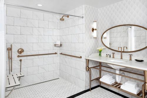 a bathroom with a sink and a mirror at Hotel LeVeque, Autograph Collection in Columbus