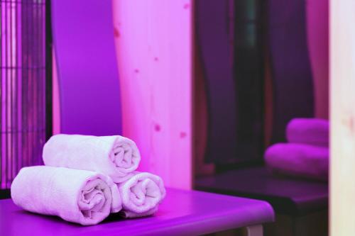 a pile of towels sitting on a purple table at Courtyard by Marriott Dresden in Dresden
