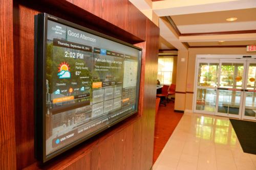 a television hanging on a wall in a building at Courtyard Middlebury in Middlebury