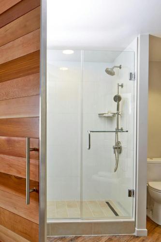 a shower with a glass door in a bathroom at The Worthington Renaissance Fort Worth Hotel in Fort Worth