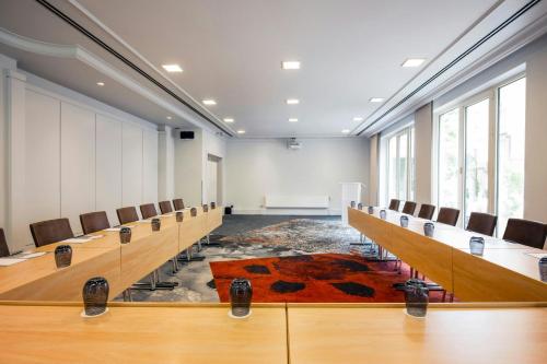 a conference room with desks and chairs and a podium at Renaissance Brussels Hotel in Brussels