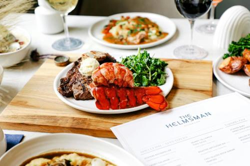 a table with plates of food and plates of food at Mystic Marriott Hotel and Spa in Groton