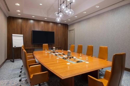a conference room with a large wooden table and chairs at Mystic Marriott Hotel and Spa in Groton