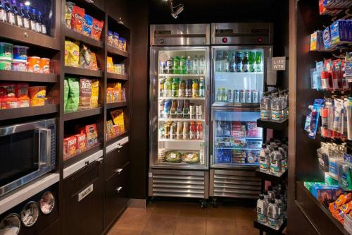 a refrigerator with its doors open in a store at Courtyard Detroit Metro Airport Romulus in Romulus