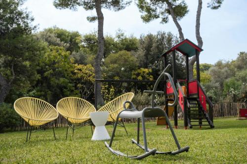 a group of chairs and a playground in a park at Mangia's Brucoli, Sicily, Autograph Collection in Brucoli