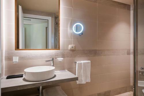 a bathroom with a sink and a mirror at Mangia's Brucoli, Sicily, Autograph Collection in Brucoli